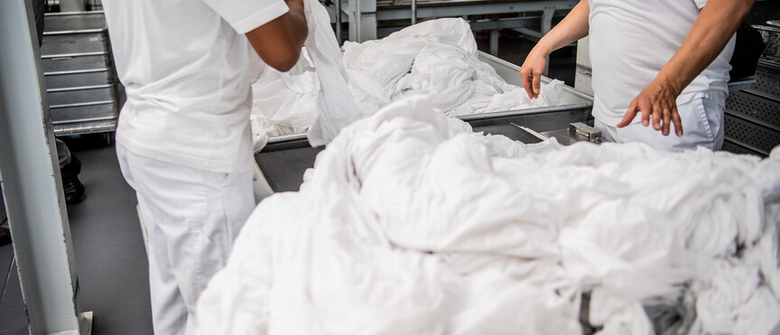 Laundry agent sorting laundry
