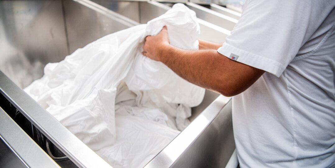 Laundry agent sorting clean laundry