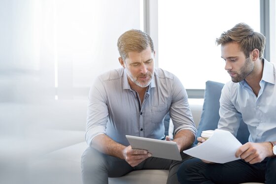 Two men discussing a professional topic in an office – business sector
