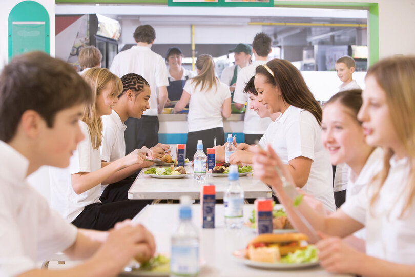 Students enjoying a meal in a school cafeteria - Balanced nutrition for everyone